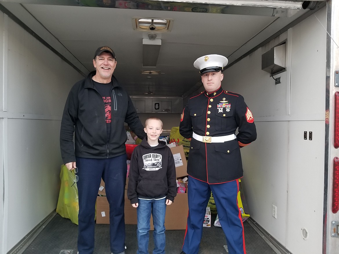 Carter Colby is pictured with KDBR &#147;The Bear&#148; radio station&#146;s morning host John Michael, and Marine Corps Sgt. Parrish at station&#146;s Toys for Tots drive Dec. 13.