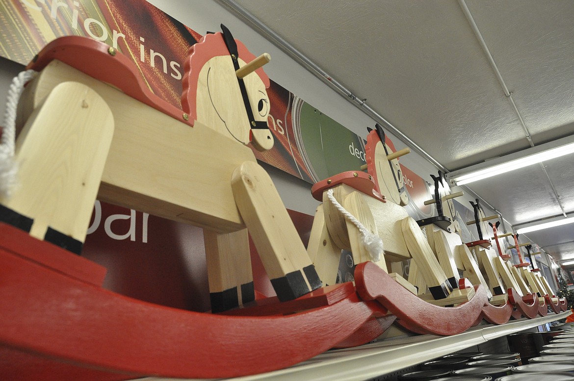 Handmade rocking horses line the paint section of Western Building Center in Polson. The childhood favorite were made with materials donated by the store and assembled by Polson High School students. (Ashley Fox/Lake County Leader)