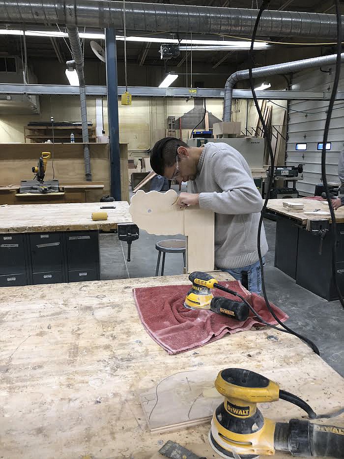 Adrian Milian works on creating the head of a rocking horse during shop class at Polson High. (Photo provided)