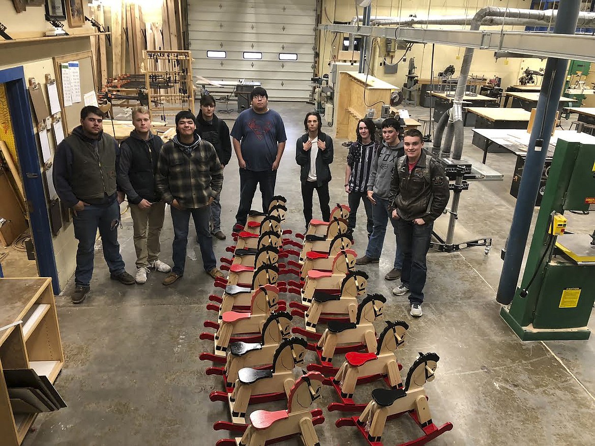 Students from the Polson High School shop class stand with their creations after the last of the rocking horses are painted and assembled. (Photo provided)