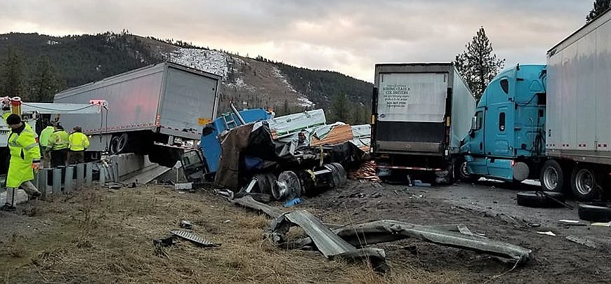 A five-semi-truck pileup closed both eastbound and westbound lanes of I-90 on Wednesday, Dec. 19. Two drivers died at the scene and one suffered a broken back. A Frenchtown Rural firefighter was also injured when he slipped on the ice and fell 40 feet off the railroad crossing bridge 10 miles east of Superior. (Photo courtesy of Scott Dodd, Superior Volunteer Fire Department)