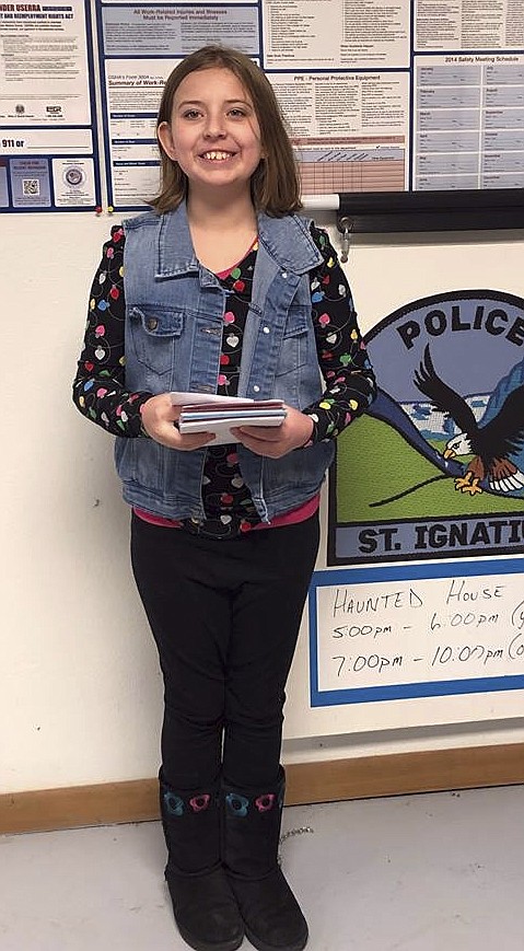 Charlotte Kinnamon,  a fifth-grader at Polson Middle School, has a tradition of passing out cards to first responders. This year, her cards will go as far as Washington, D.C., in the states, while bundles go to soldiers overseas. (Photo courtesy of Cassey Kinnamon)