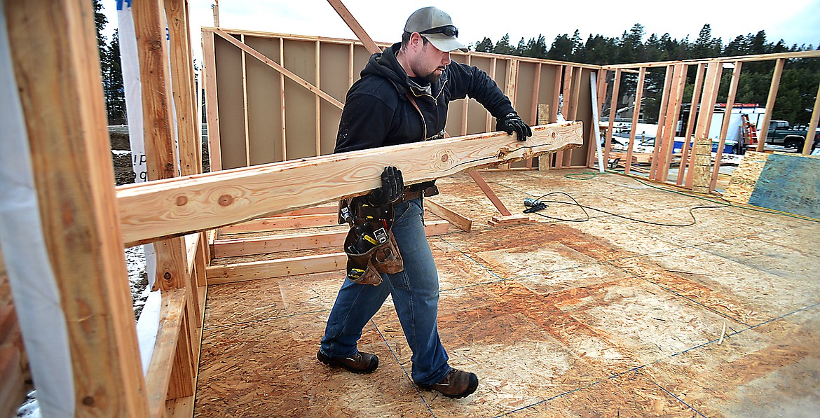 A crew from Ron Terry Construction works on a home being build at Log Yard Court in the Mill Creek Subdivision in Bigfork on March 6, 2014.(Brenda Ahearn/Daily Inter Lake)