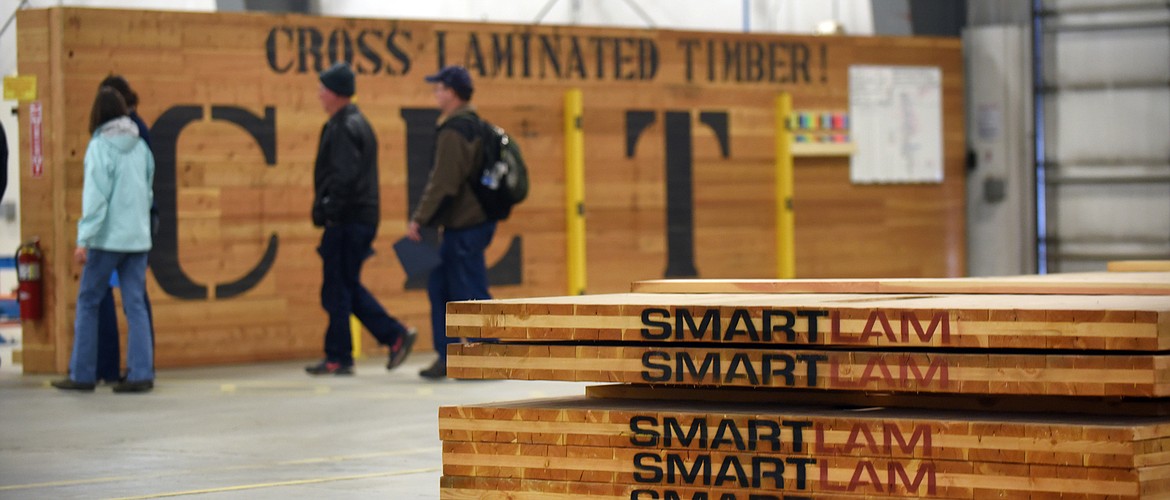 Attendees on the annual Timber Tour walks past the Cross Laminated Timber display at SmartLAM on Thursday, October 22, 2015 in Columbia Falls.(Brenda Ahearn/Daily Inter Lake)