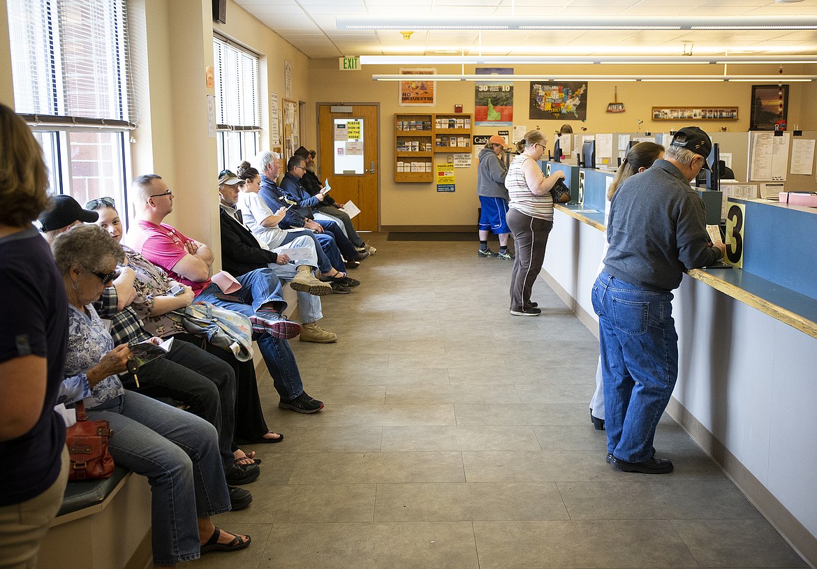 Customers wait in line at the Kootenai County Department of Motor Vehicles in Coeur d&#146;Alene last summer. Population growth helped contribute to longer lines at local DMV offices.