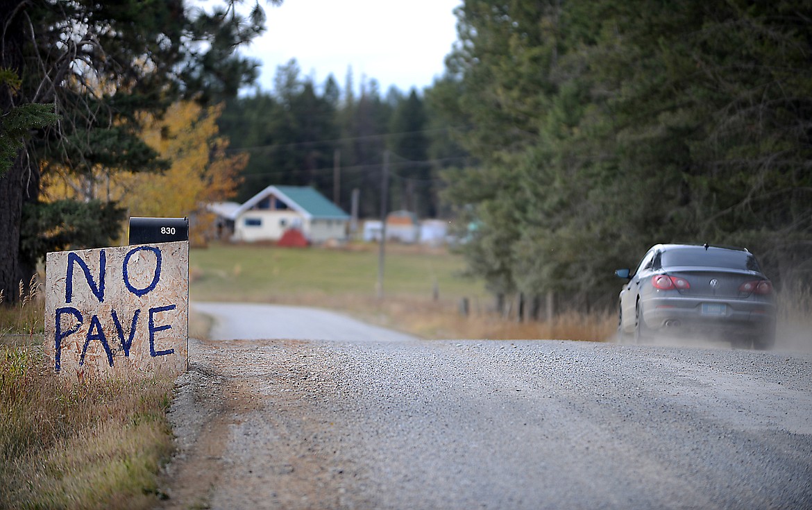 A home-made sign clearly shows one person's position on the question of whether or not K M Ranch Road should be paved or left as gravel on Tuesday, October 14, 2014 between Kalispell and Whitefish.(Brenda Ahearn/Daily Inter Lake)