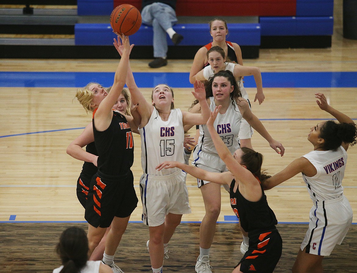 Coeur d&#146;Alene&#146;s Tori Younker (15) and Genna Gardiner of Post Falls go for a rebound during Tuesday night&#146;s game at Viking Court. (LOREN BENOIT/Press)