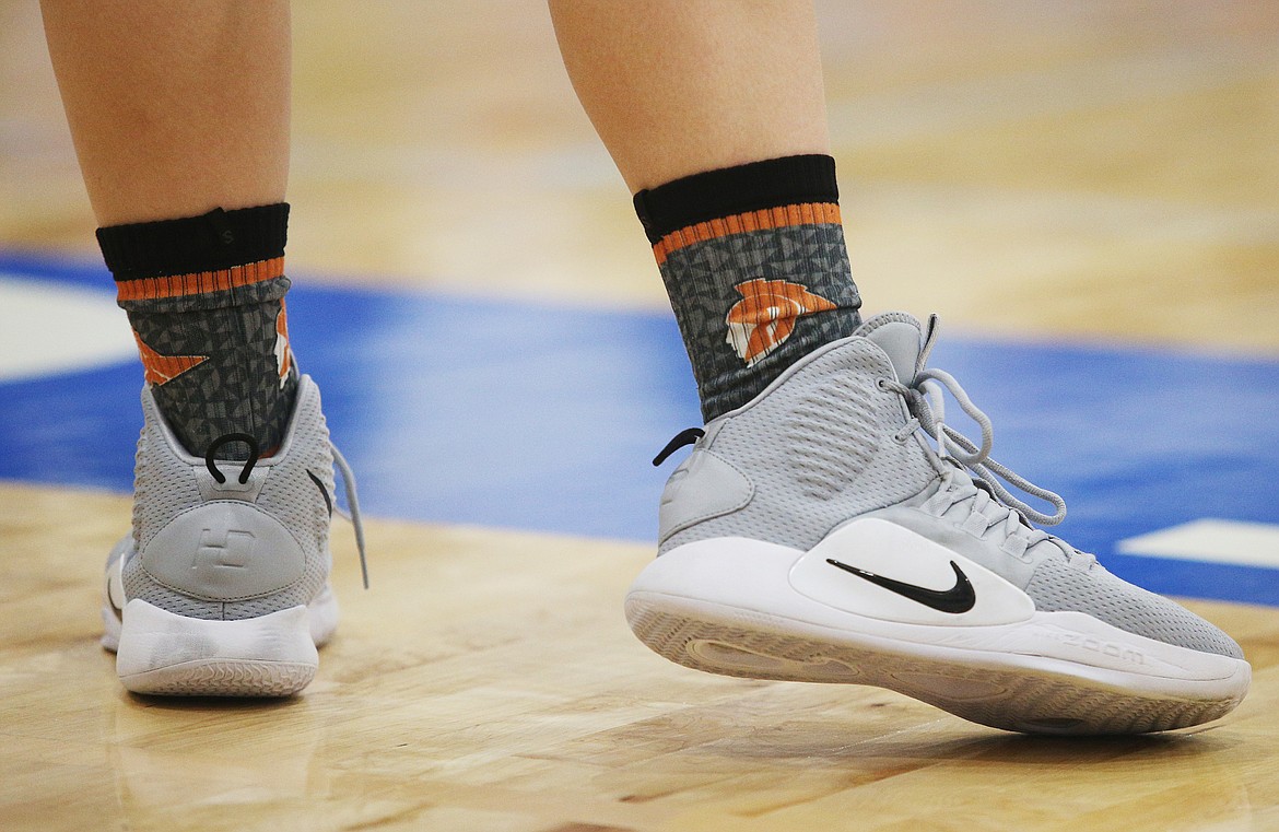 A Post Falls girls varsity basketball player sports themed socks during a game against Coeur d&#146;Alene. (LOREN BENOIT/Press)