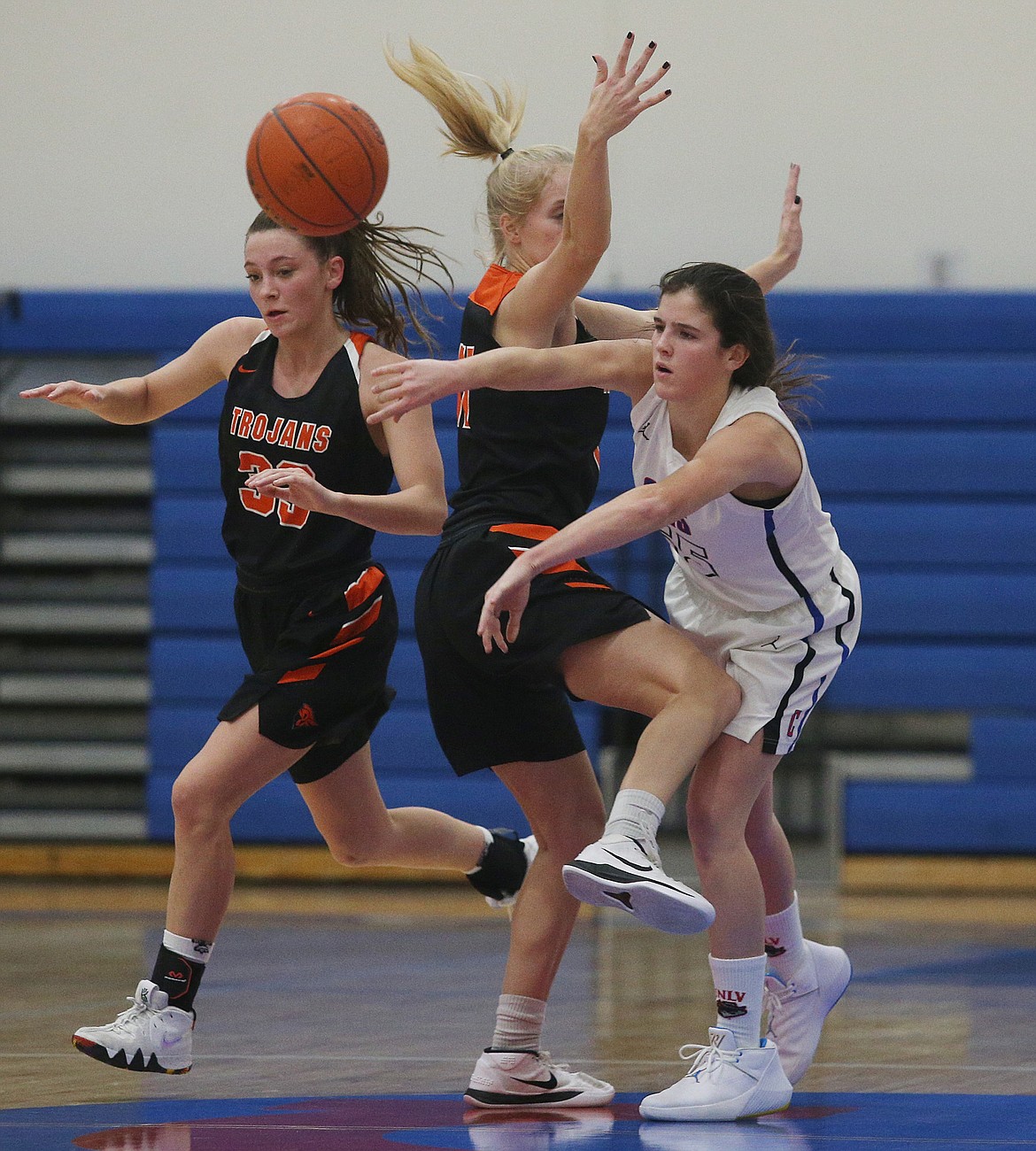 Coeur d&#146;Alene&#146;s Skylar Burke passes the ball to a teammate while defended by Jenna Gardiner of Post Falls. (LOREN BENOIT/Press)