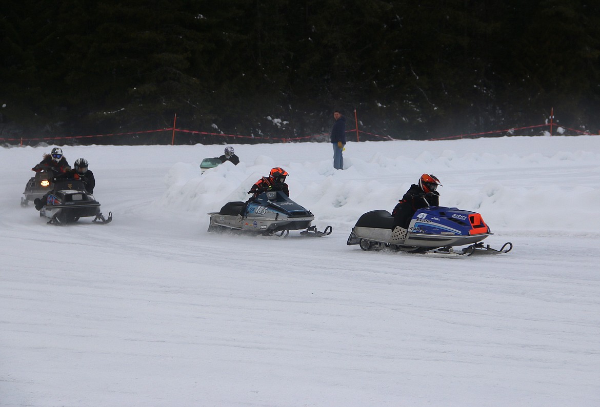 (Photo by MARY MALONE)
A group of racers navigate a turn during the Priest Lake Vintage Snowmobile Races on Saturday.