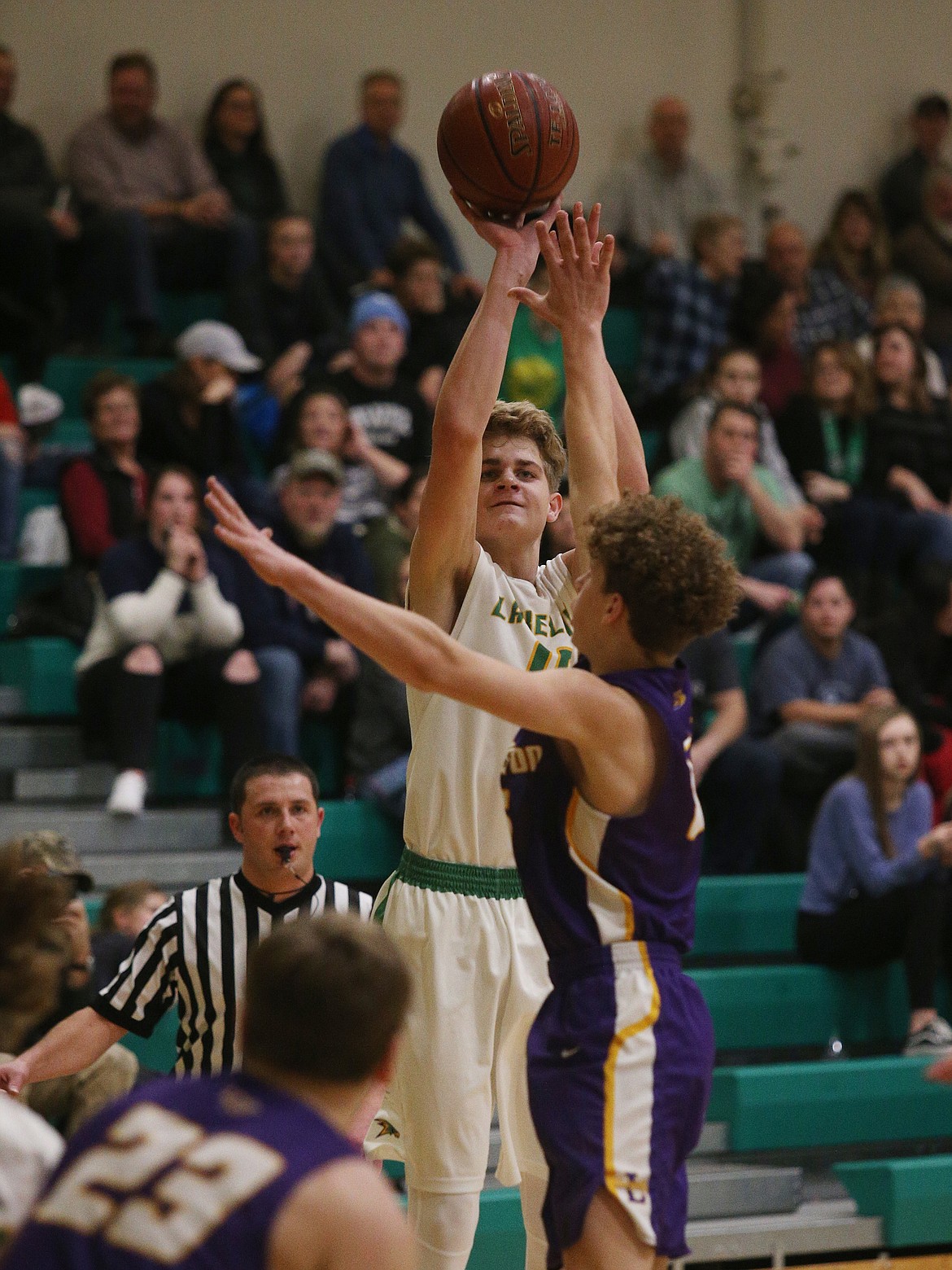 Lakeland&#146;s Noah Haaland shoots a 3 over Lewiston defender Jace McKarcher in Thursday night&#146;s game at Lakeland High.