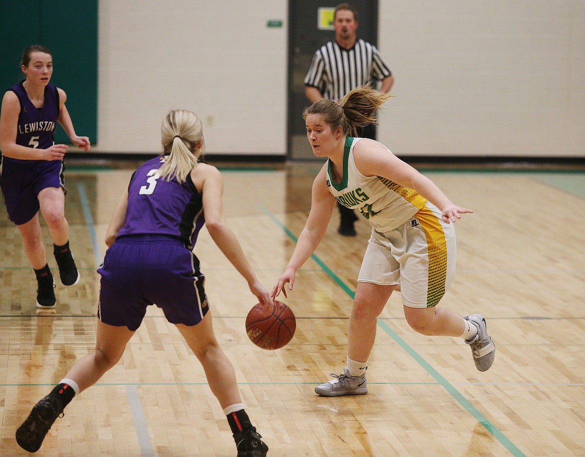 Alaina Pruitt of Lakeland dribbles the ball in front of Lewiston defender Hally Wells.