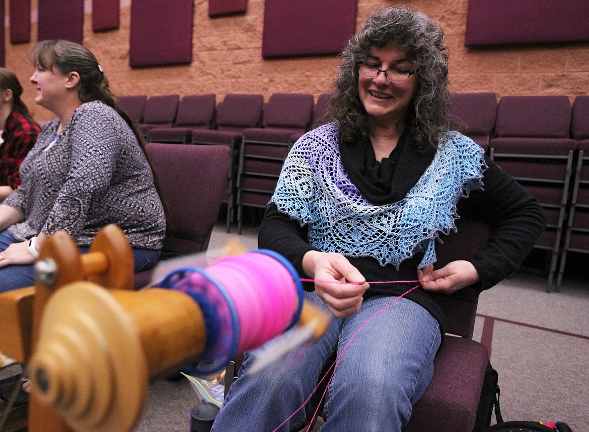 Photos: DEVIN WEEKS/Press 
Annemarie Wright of Coeur d&#146;Alene gently pulls hot pink alpaca yarn from her spinning wheel Saturday during the St. Distaff&#146;s Day Spin at in the Lutheran Church of the Master in Coeur d&#146;Alene.