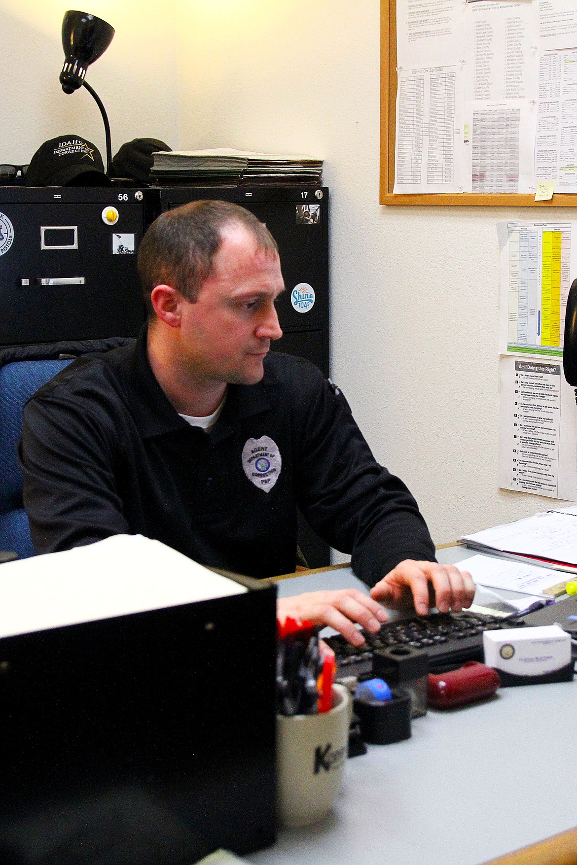 Lewis-Clark State College Outstanding Alumni for fall 2018, Clinton Blettner works in his office in Coeur d&#146;Alene. He is the lead probation and parole officer for Idaho District 1. (ANDREAS BRAUNLICH/Press)