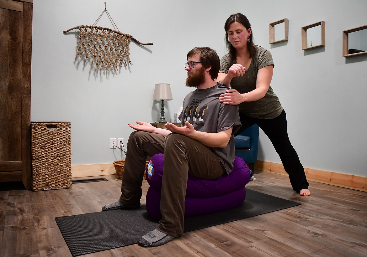 Kelsey Holmes demonstrates her yomassage technique with the help of her husband, Nate Stoltzfus. (Jeremy Weber photo)