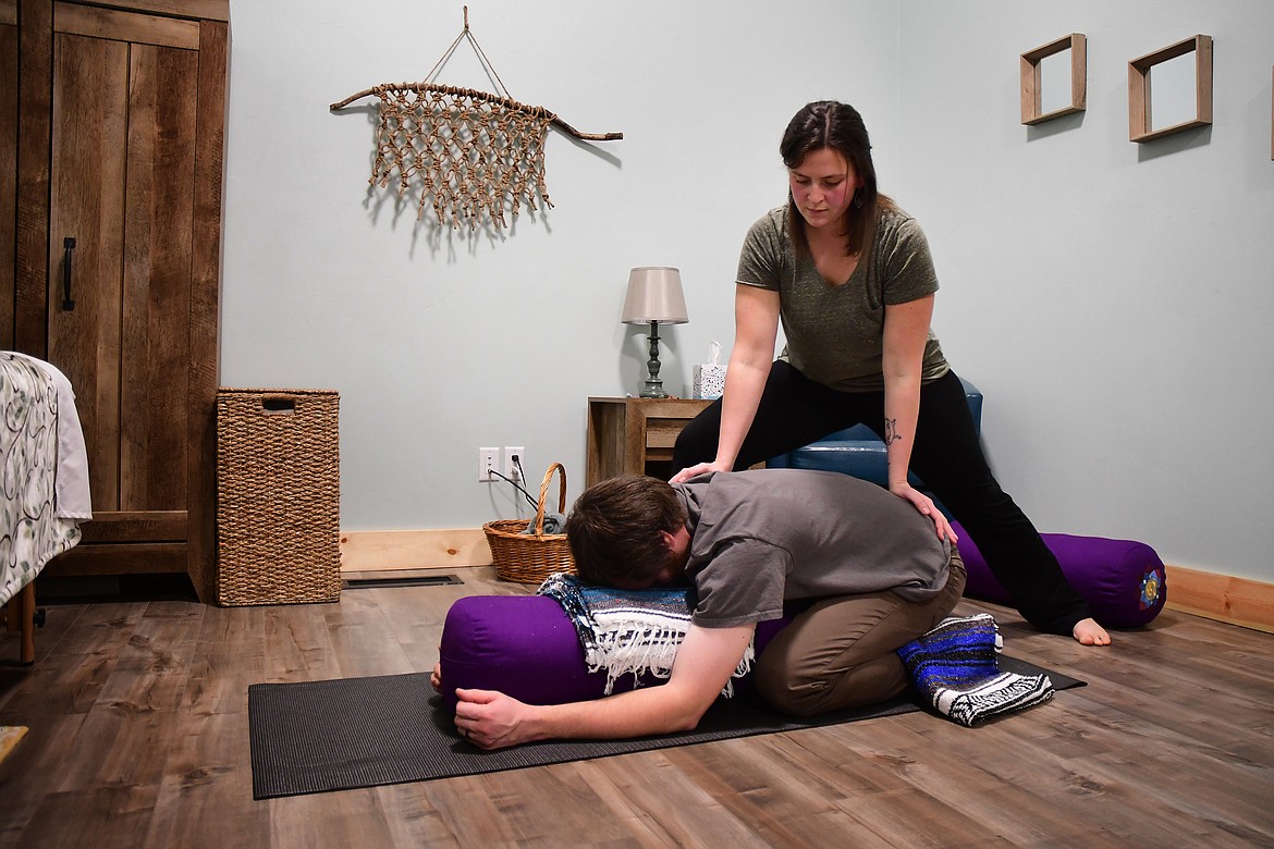 Kelsey Holmes demonstrates her yomassage technique with the help of her husband, Nate Stoltzfus. (Jeremy Weber photo)