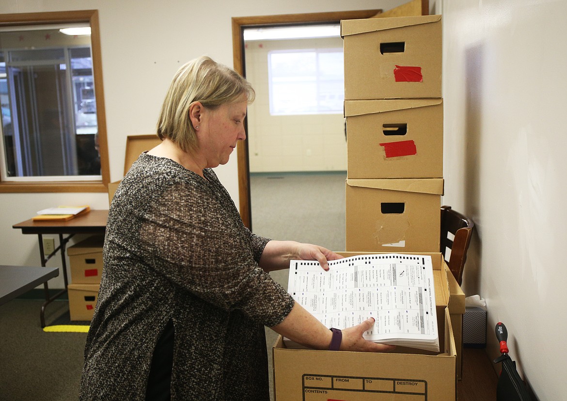 Grace Studer with the Kootenai County Elections Office places recounted early and absentee ballots in a box Wednesday morning. The recount was ordered to ensure every early and absentee vote was counted. A specific resident or complaint did not prompt the recount. (LOREN BENOIT/Press)