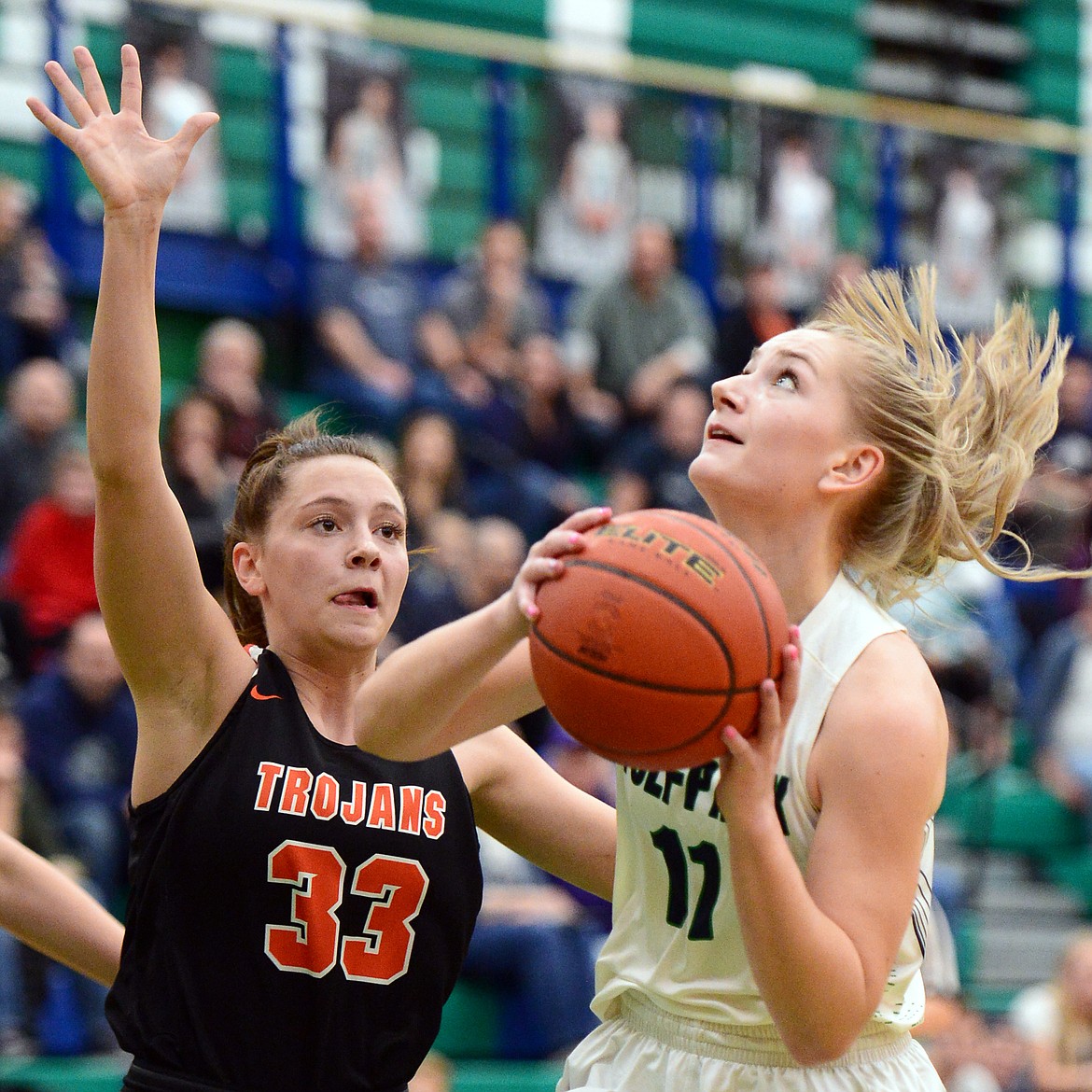 Glacier&#146;s Kaileigh Crawford (11) looks to shoot with Post Falls&#146; Dylan Lovett (33) defending at Glacier High School on Friday. (Casey Kreider/Daily Inter Lake)