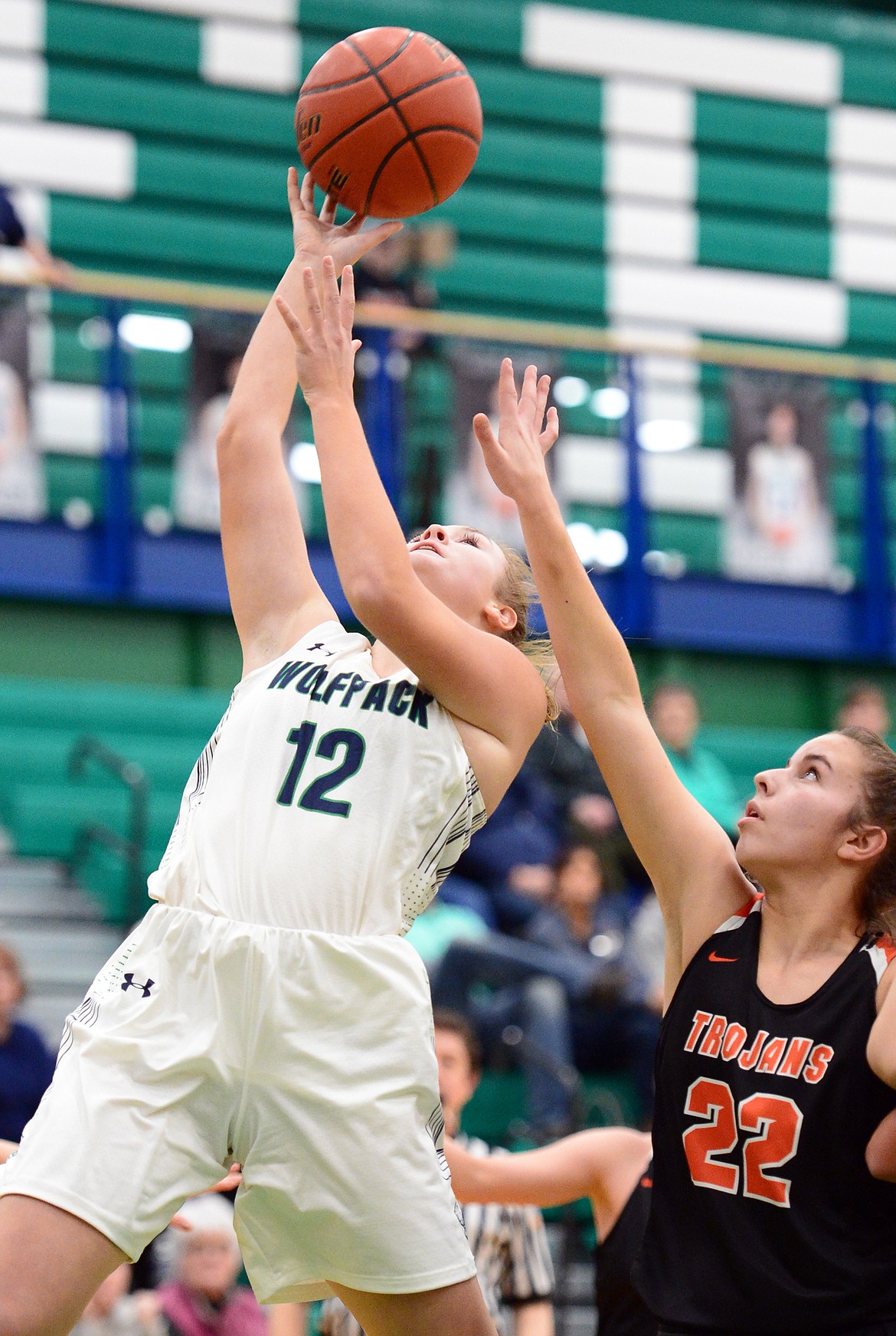 Glacier's Kenzie Williams (12) drives to the basket past Post Falls' Kennedy LaFountaine (22) at Glacier High School on Friday. (Casey Kreider/Daily Inter Lake)