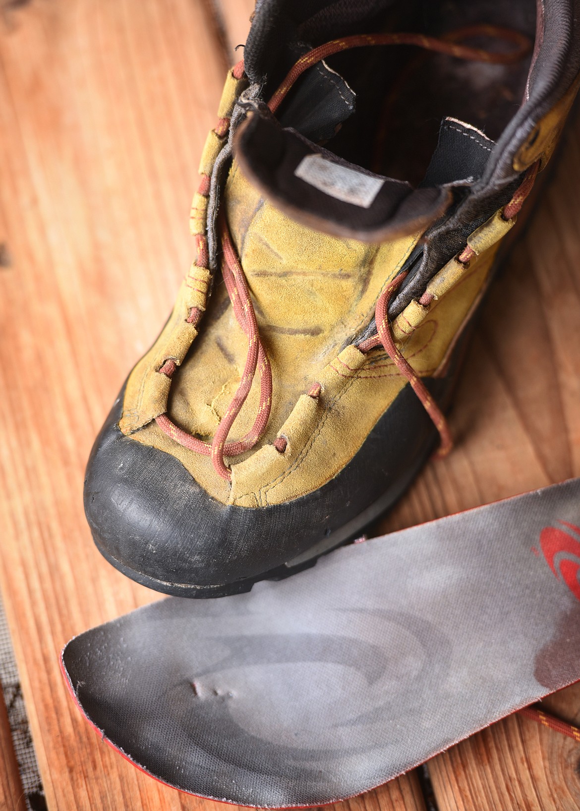 Detail photo of Anders Broste's left book. Broste said he was told that a grizzly bear bite could be as strong as 1,200 pounds per inch. His boot has penetrating teeth marks in both the top and bottom of the shoe and even the insert he wore was broken through.(Brenda Ahearn/Daily Inter Lake)