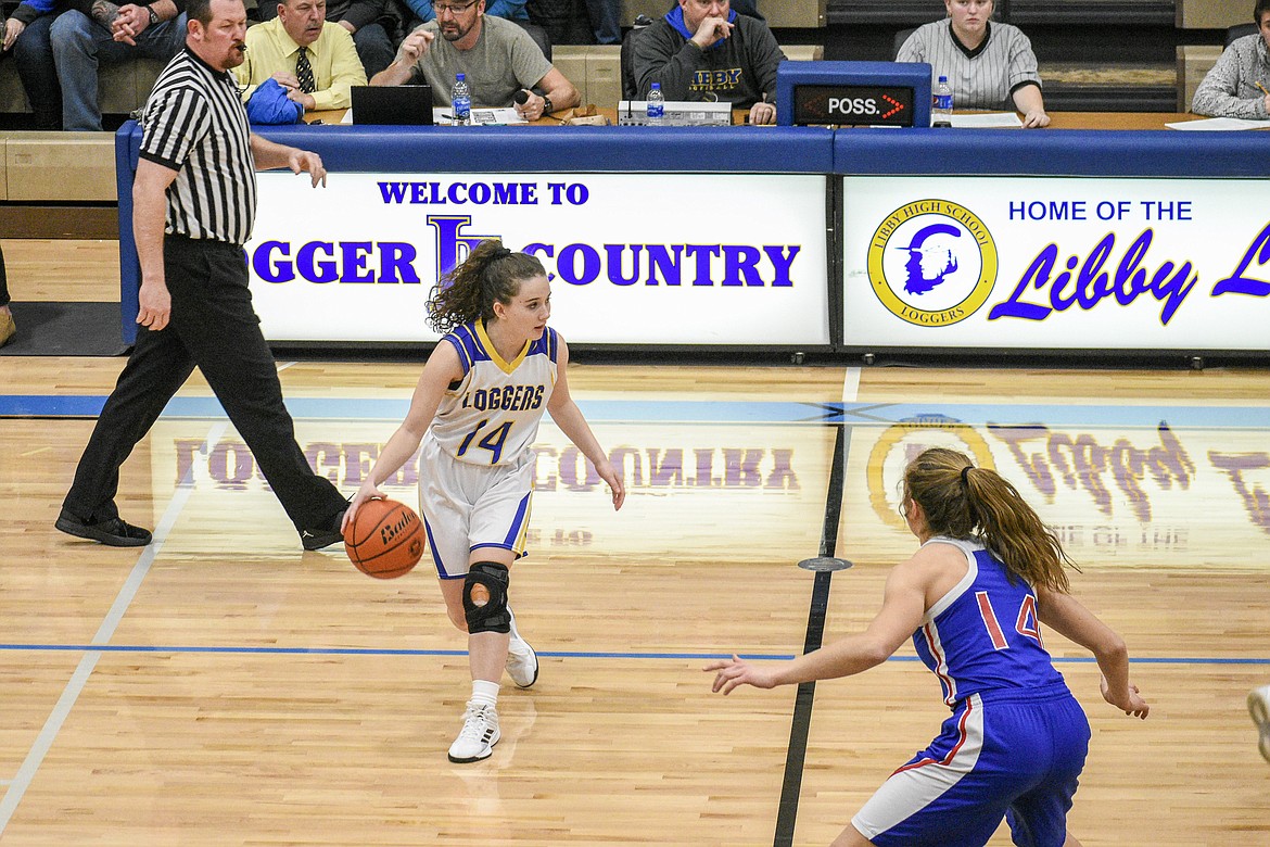 Libby senior Emma Gruber looks for her opening at half court moments before driving in for a three-point shot to take a 3-2 lead over Columbia Falls during the first quarter in Libby Friday. (Ben Kibbey/The Western News)