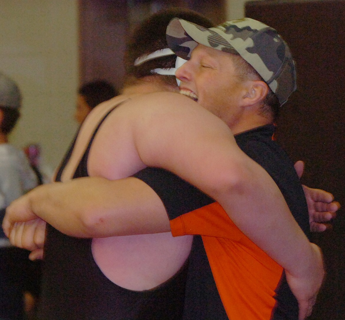 Plains/Hot Springs heavyweight class wrestler Steven Yother gets a congratulatory hug from assistant coach Rocky Wagner after Yother won his first match of the season last weekend at the Western Montana Duals in Ronan. (Joe Sova/Clark Fork Valley Press)