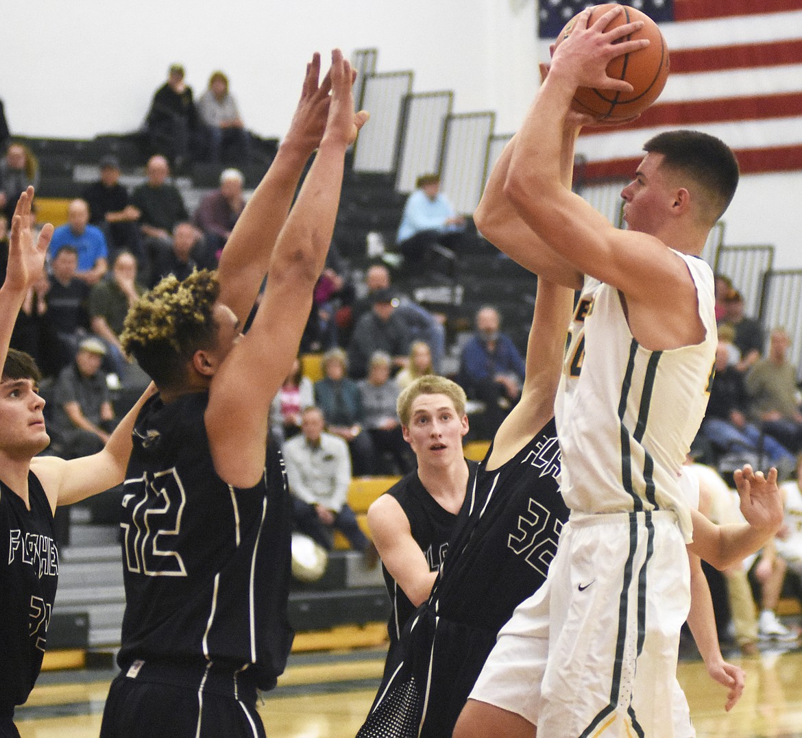 The entire Braves defense swarms Lee Walburn during Friday's 59-51 win over Flathead. (Daniel McKay/Whitefish Pilot)