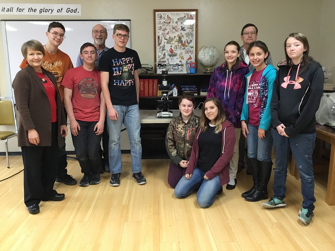 Cabinet Peaks Medical Center recently donated an Olympus Pathologist Grade Microscope to Kootenai Valley Christian School. Pictured are: KVCS Administrator Ruthanne Dolezal, Logan Marcott, Aiden James, 7th-12th grade Science Teacher David Iliff, Landon Marcott, Kaylin Siefke, Taylor Ballesteroz, Hannah Schertel, Cabinet Peaks Laboratory Department Manager Roger Riddle, Mikaliana O’Rourke and Beth James. (Courtesy photo)