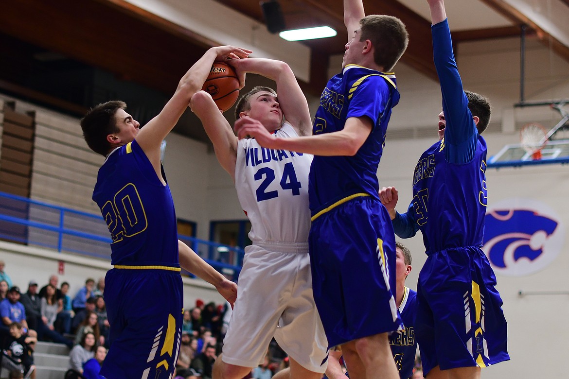 Wildcat Logan Bechtel is blocked by Libby&#146;s Ryan Goodman during action in the second quarter Thursday. (Jeremy Weber photo)