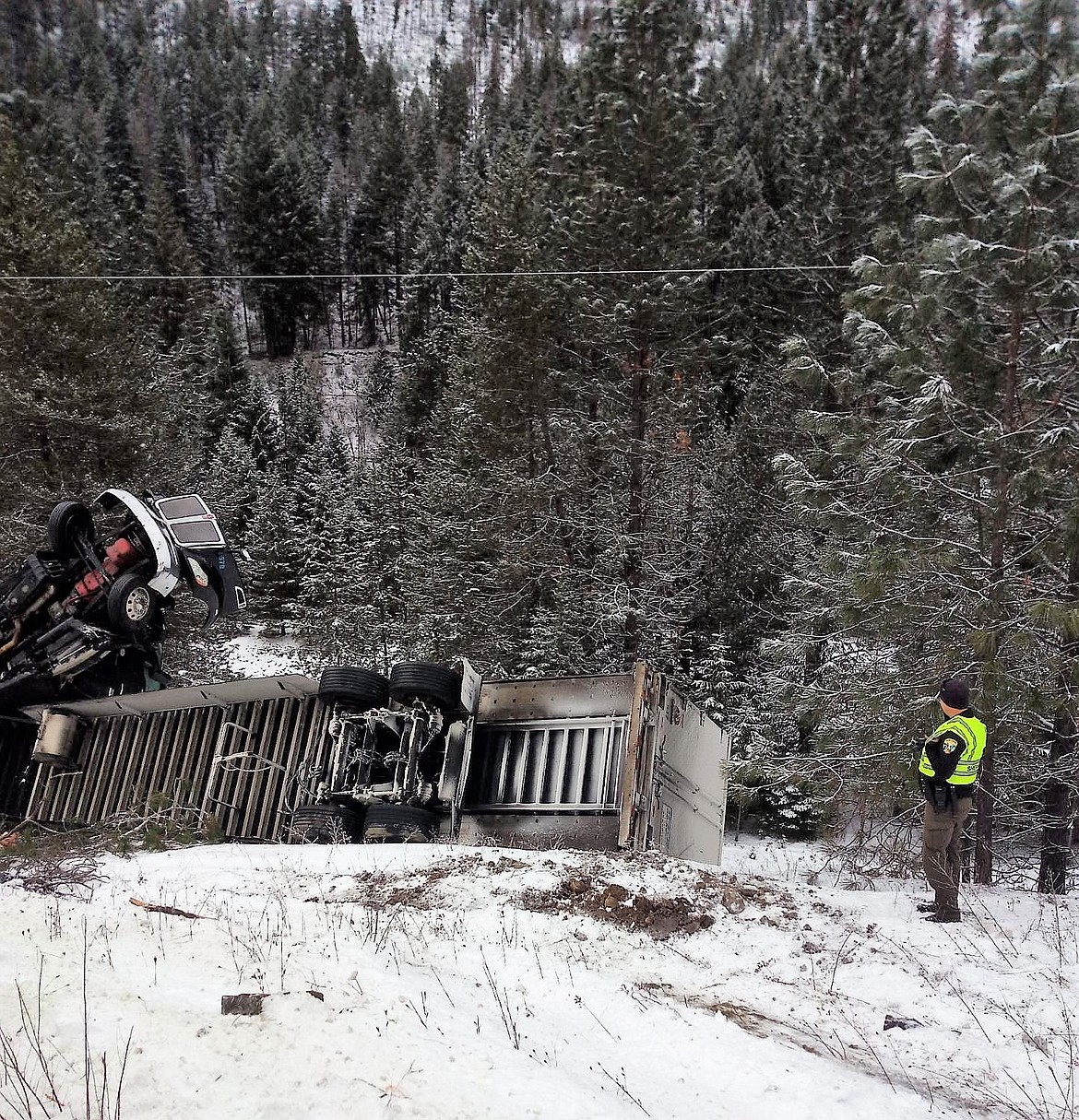 A semi-truck carrying beer tipped over on I-90 near St. Regis on Jan. 1, nearly hitting electrical lines. No injuries were reported. (Photo courtesy of Kat Kitteridge)