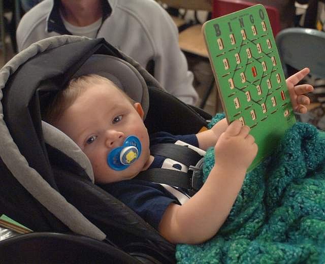 SEVEN-MONTH-OLD Kason Ludeman was probably the youngest OGNIB player during the Hot Springs Lions Club fundraiser on Sunday, Nov. 18 in the Hot Springs School multi-purpose room. There were three winners in each OBNIB game, allowing lots of people to take home food for their Thanksgiving meal. (Joe Sova/Clark Fork Valley Press)