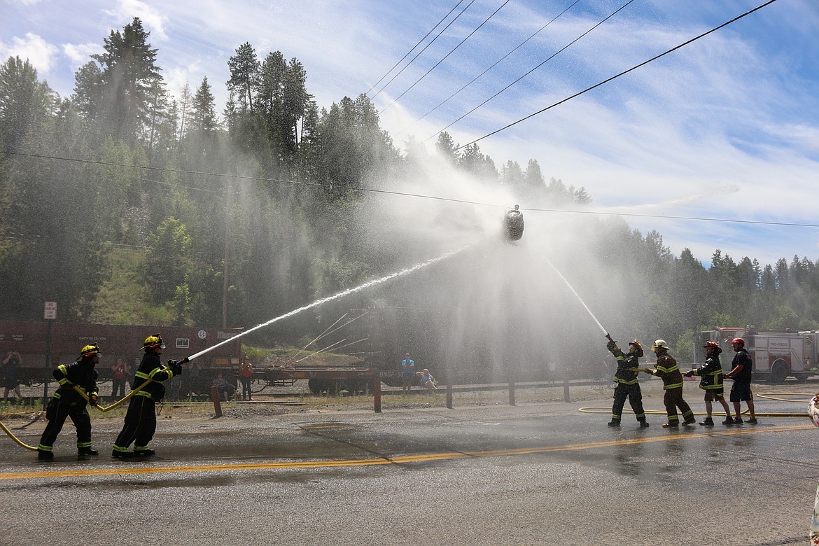 Photo by MANDI BATEMANFirefighters taking part in the beer barrel competition during the seventh annual Firefighter Competition and Demonstration on the Fourth of July.