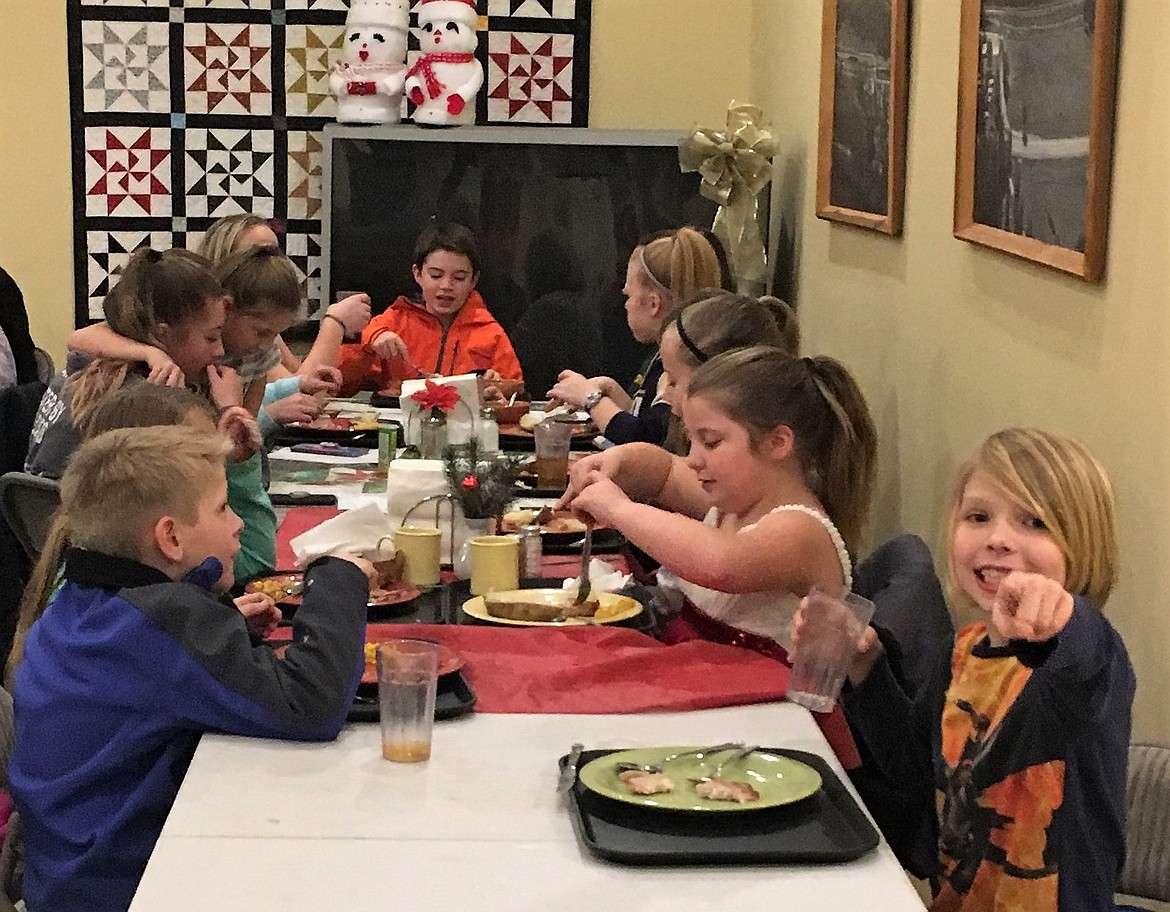 The St. Regis 4-H group enjoyed a meal at the St. Regis Senior Center on Dec. 14 after singing songs to the group. (Photo courtesy of St. Regis 4-H)