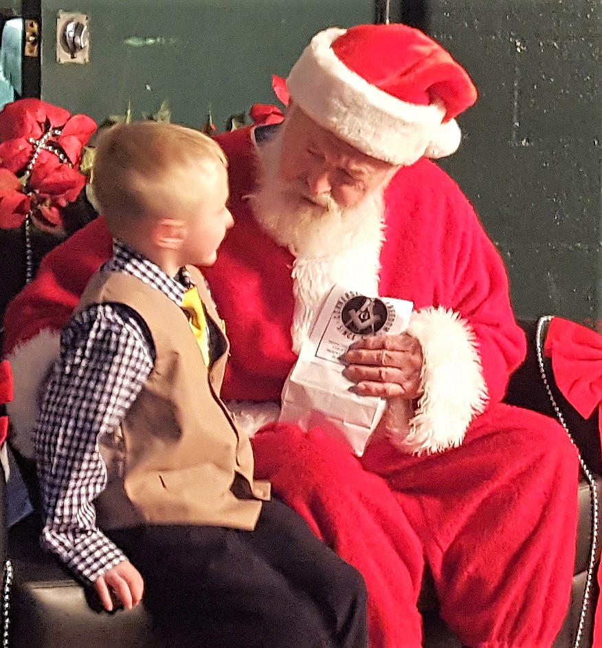 Santa (aka Ron Forest) asks children what they want for Christmas during the evening of the St. Regis School&#146;s Winter Concert held on Dec. 18. (Photo courtesy of Joe Steele)