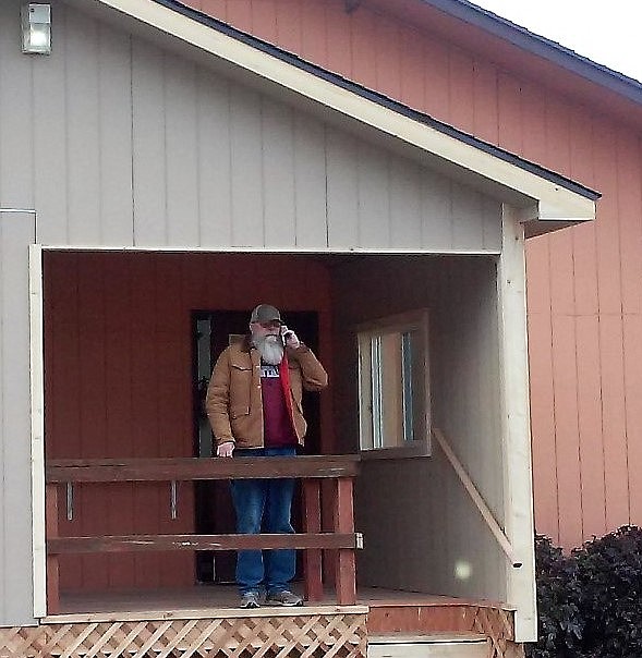 GLENN KOEPKE stands on the porch of a new addition on the St. Regis Community Center. He was instrumental in getting the addition built to house the Mineral County Food Commodity Program. (Photo courtesy of Liz Gupton)