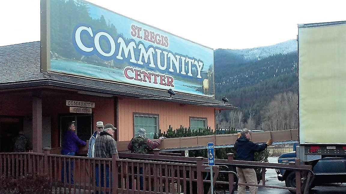 VOLUNTEERS UNLOAD food from a truck for the Mineral County Food Commodity Program, coordinated by Patti Curtin and Donna Richter. An addition was built onto the St. Regis Community Center to house the project with fundraising help by Curtin. (Photo courtesy of Liz Gupton)