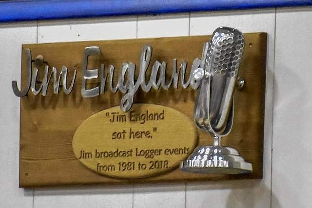 The plaque in the Ralph Tate Memorial Gym that commemorates the nearly four decades Jim England called Logger basketball from the KLCB booth. (Ben Kibbey/The Western News)