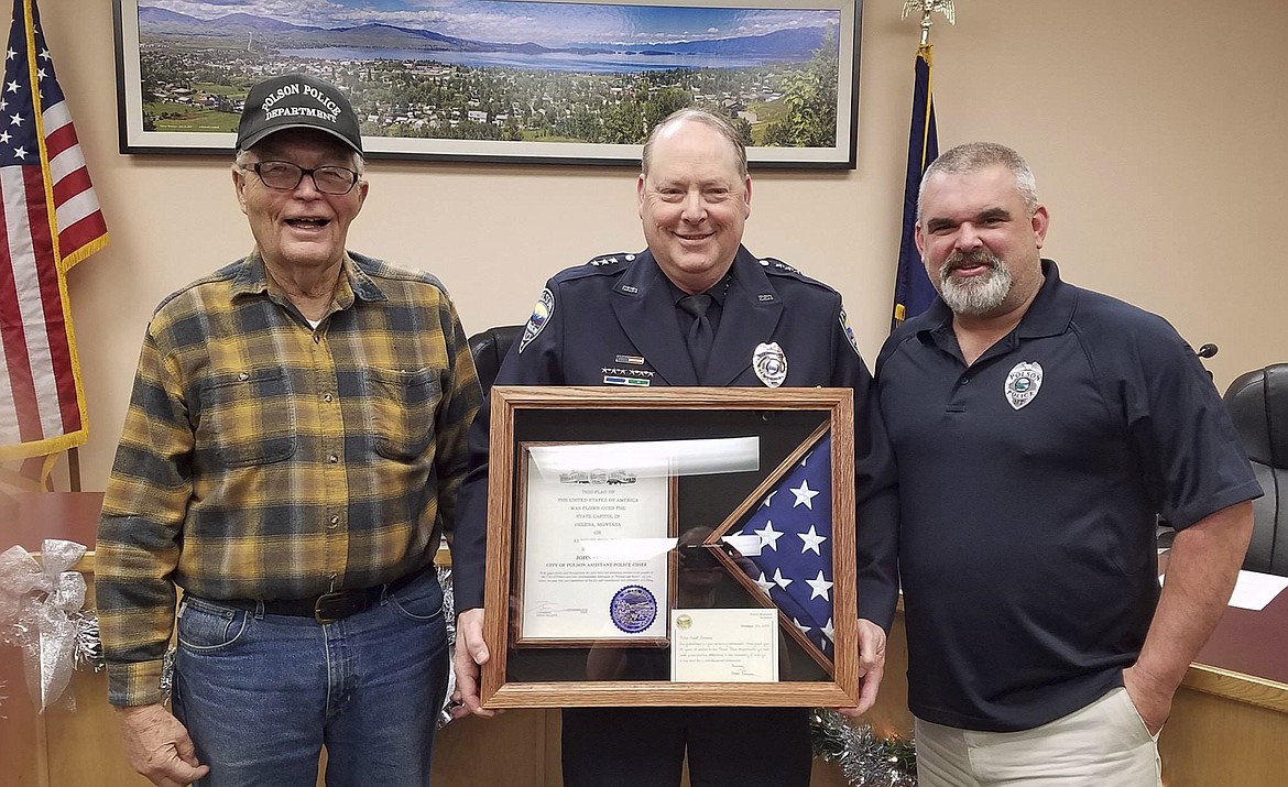 During a Dec. 17 Polson City Commissioners&#146; meeting, Assistant Police Chief John Stevens, center, is recognized for his service with former Polson Police Chief Ron Buzzard, left, and current Police Chief Wade Nash, right. (Photo courtesy of Polson Police Department)