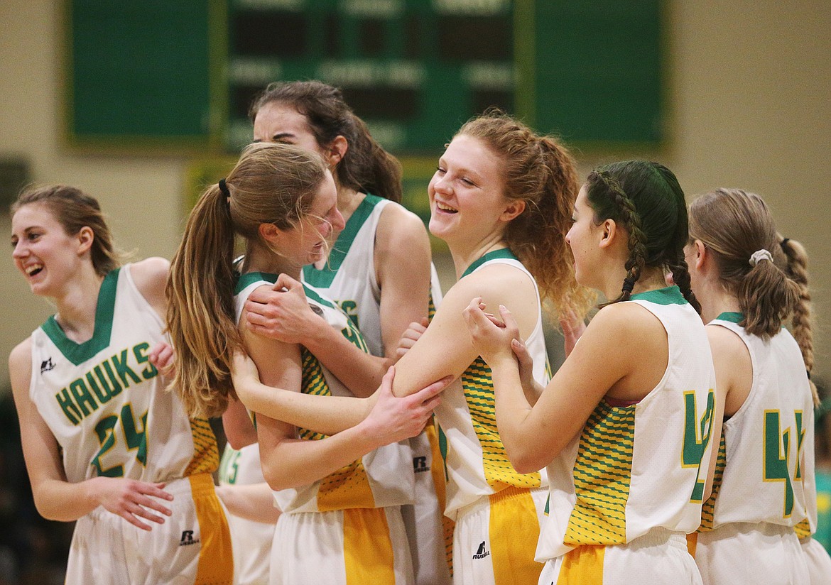 The Lakeland girls basketball team celebrates its 49-35 win over the Sandpoint Bulldogs in the Battle for the Paddle spirit game at Hawk Court in Rathdrum on Friday. 

LOREN BENOIT/Press