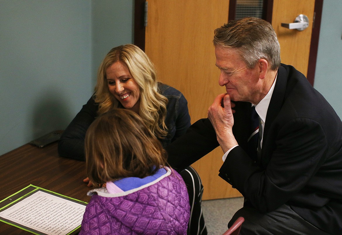 Gov. Brad Little and Principal Lynn Paslay listen as student Avy Murphy reads a 2nd grade short story to Little during his visit Friday to Betty Kiefer Elementary School. (LOREN BENOIT/Press)