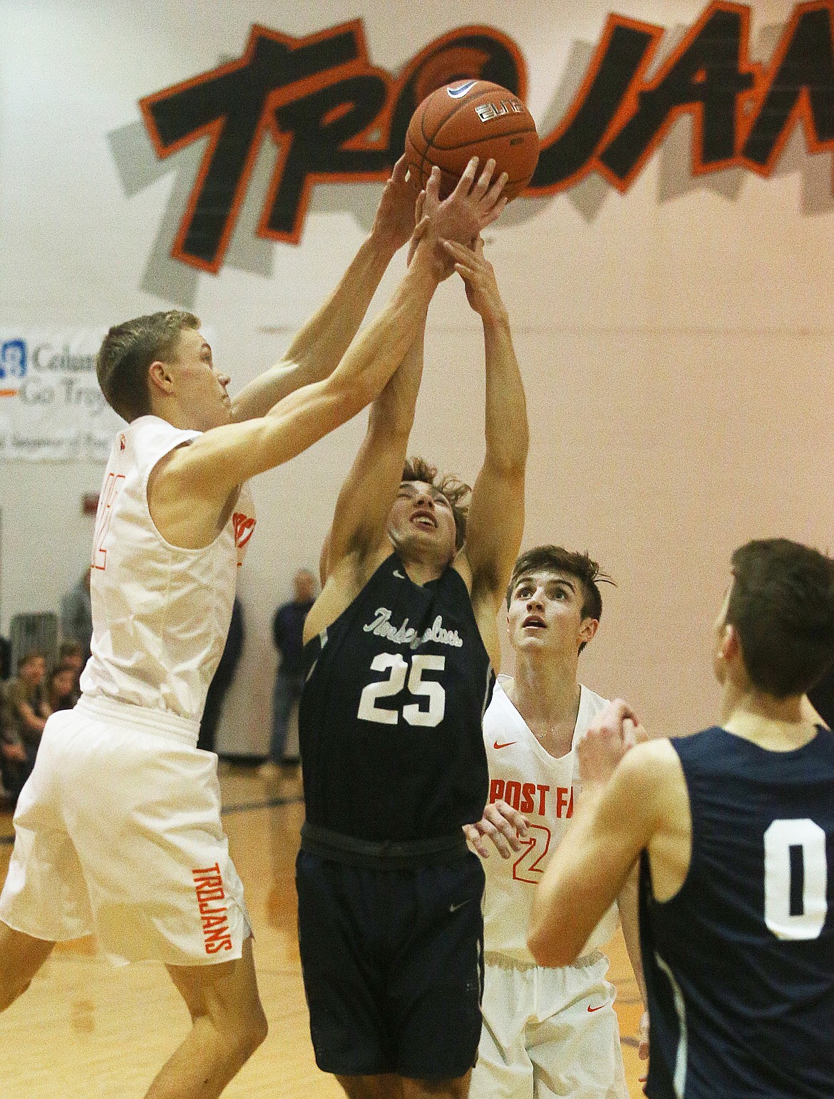 Post Falls guard Gavven Desjarlais, left, and Dylan Brum battle for a rebound in the second half of Tuesday night's game in Post Falls. (LOREN BENOIT/Press)