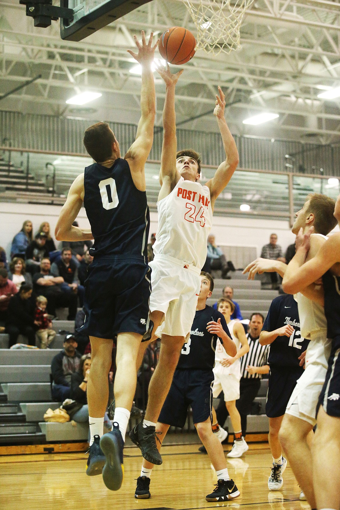 Post Falls guard Alex Horning shoots a layup while defended by Lake City's Josh Stellflug during Tuesday night's game in Post Falls. (LOREN BENOIT/Press)