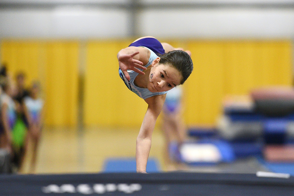 Lilah Rodriguez, from Flathead Gymnastics Academy, performs a Tsukahara vault at the 4th annual Glacier Challenge at the Flathead County Fairgrounds Trade Center in Kalispell on Saturday. (Casey Kreider/Daily Inter Lake)