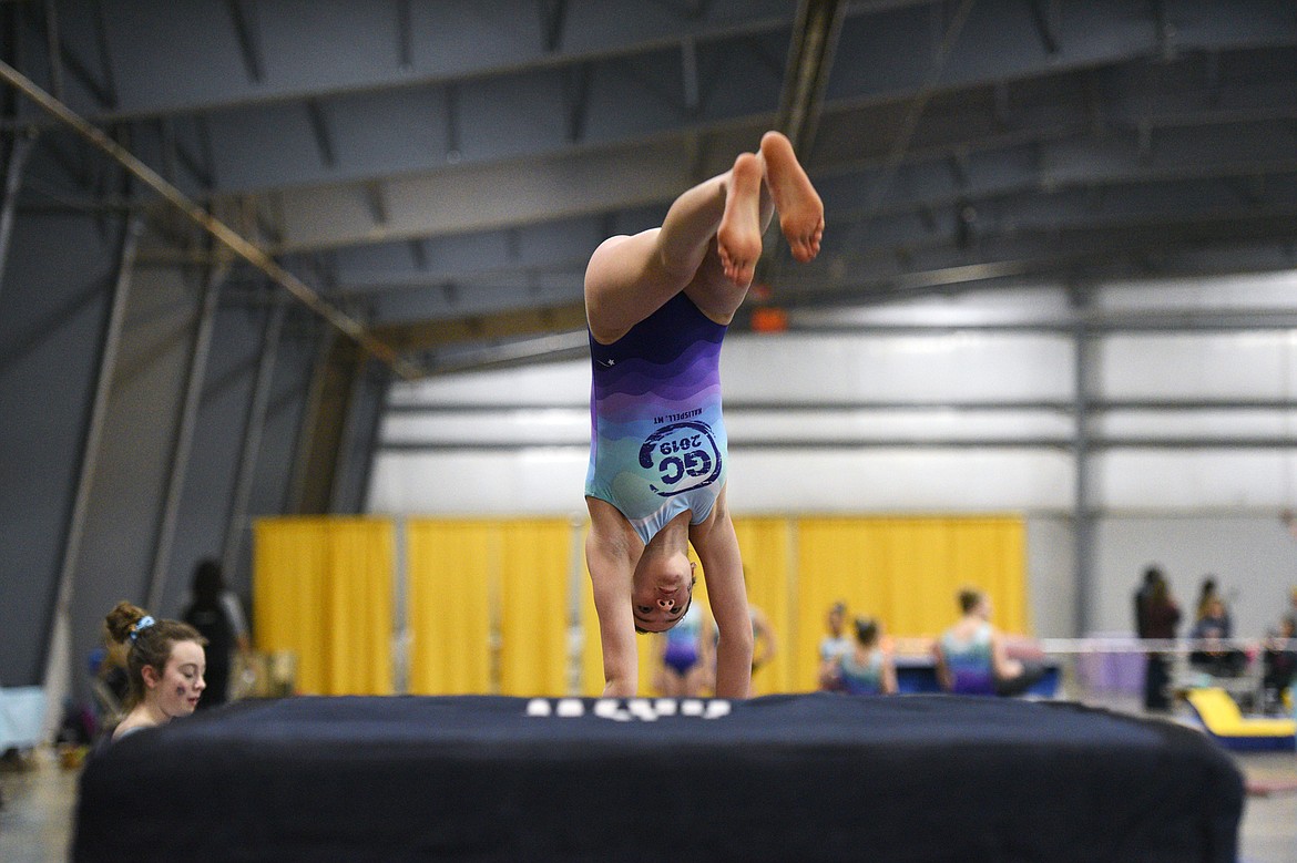 Nora Iams, from Flathead Gymnastics Academy, performs a Tsukahara vault at the 4th annual Glacier Challenge at the Flathead County Fairgrounds Trade Center in Kalispell on Saturday. (Casey Kreider/Daily Inter Lake)