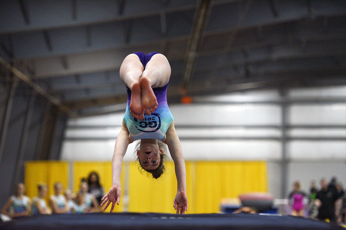 Shalayne Ostler, from Flathead Gymnastics Academy, performs a Yurchenko vault at the 4th annual Glacier Challenge at the Flathead County Fairgrounds Trade Center in Kalispell on Saturday. (Casey Kreider/Daily Inter Lake)