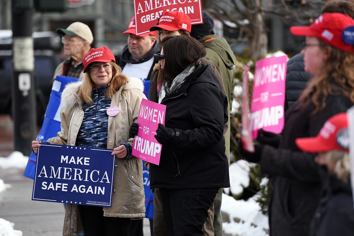 Attendees hold signs during a rally in support of President Donald Trump along East Center Street in Kalispell on Saturday. (Casey Kreider/Daily Inter Lake)