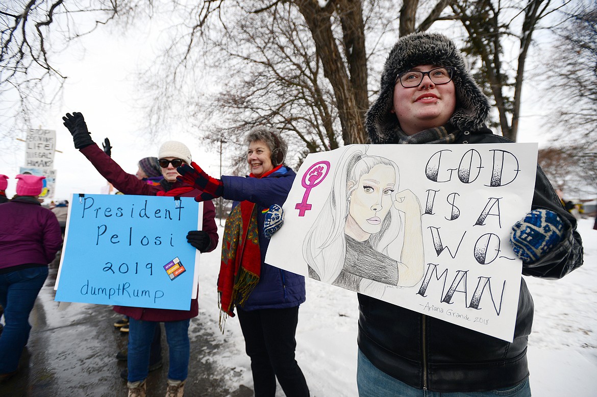 Maverick Kalvig, of Kalispell, holds a sign at the Kalispell Women's March at Depot Park on Saturday. (Casey Kreider/Daily Inter Lake)