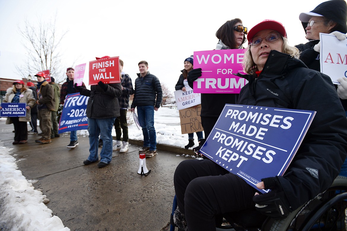 Lucinda Hardy, of Columbia Falls, holds a sign at a rally in support of President Donald Trump along East Center Street in Kalispell on Saturday. (Casey Kreider/Daily Inter Lake)