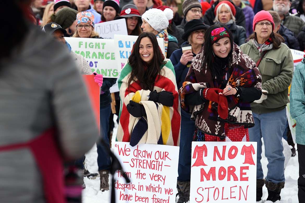 Attendees of the Kalispell Women's March hold signs and listen to speakers at Depot Park on Saturday. (Casey Kreider/Daily Inter Lake)