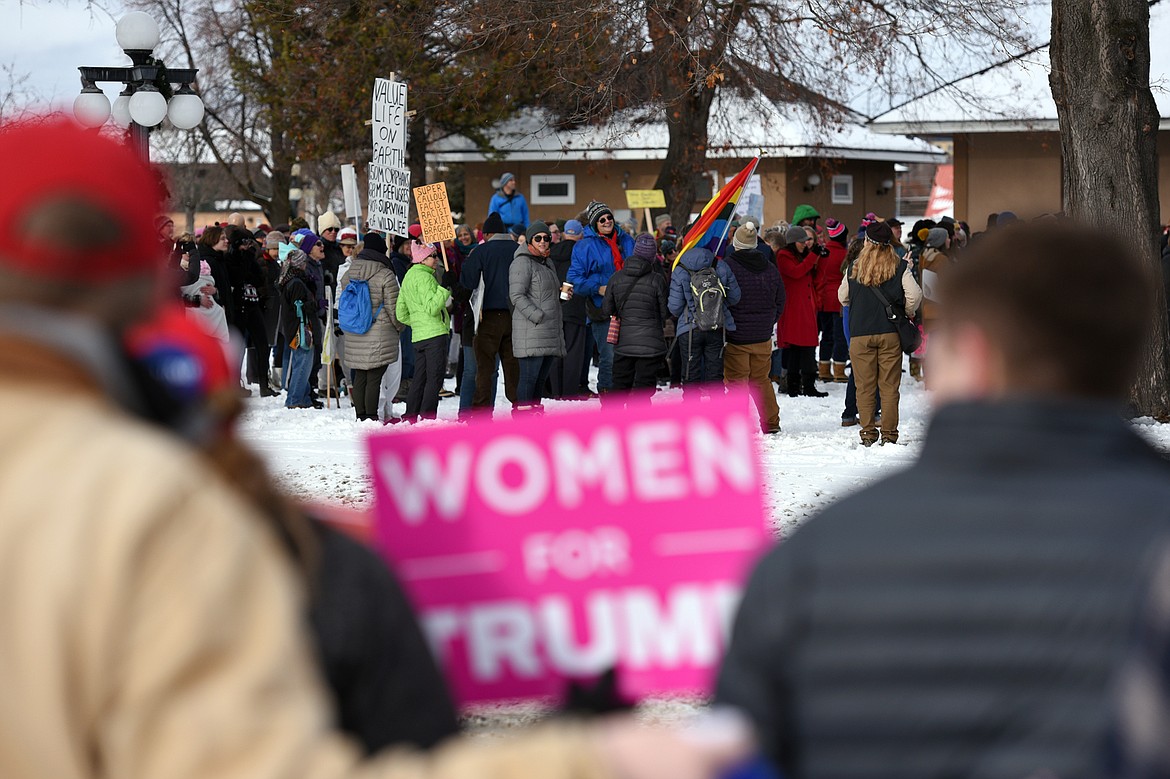 Attendees of a rally in support of President Donald Trump hold signs along East Center Street, across the street from the Kalispell Women's March held at Depot Park in Kalispell on Saturday. (Casey Kreider/Daily Inter Lake)